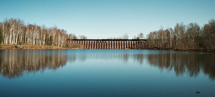 wide shot across lake to upstream side of dams